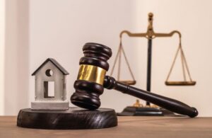 model house and gavel and legal scales