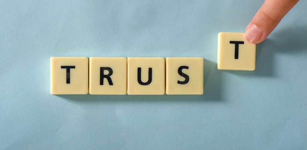 trust tile letters being moved into place